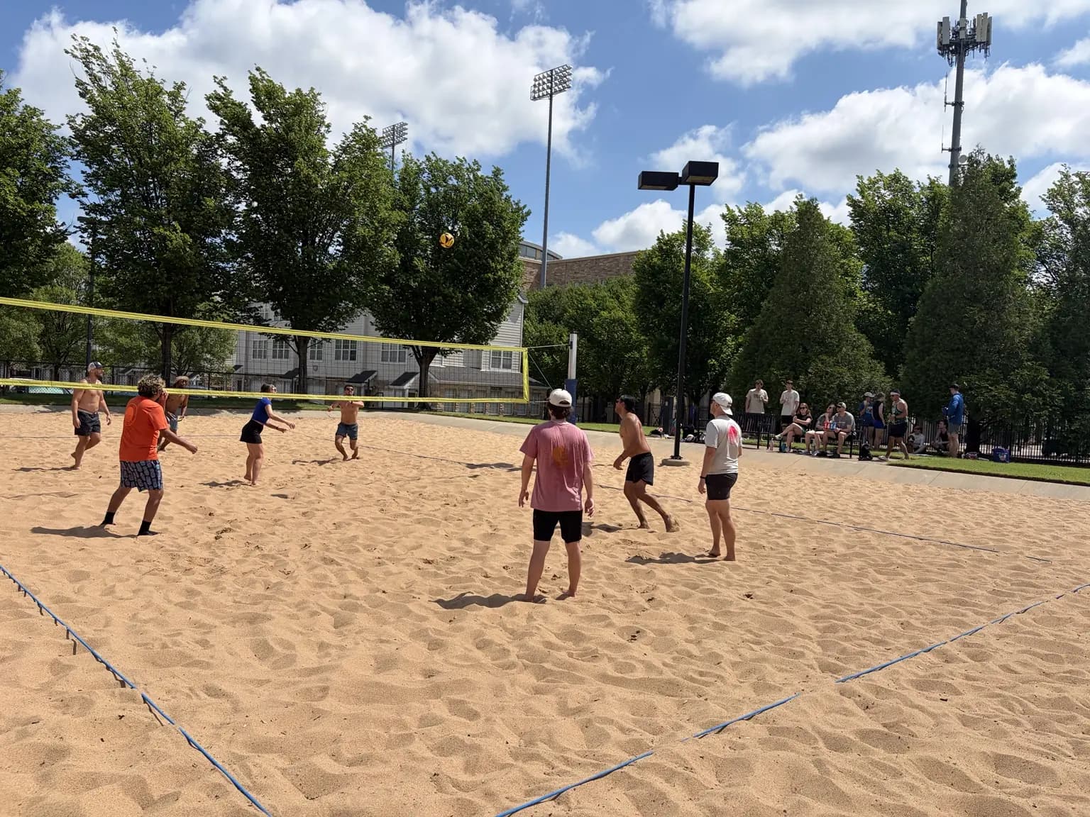 A full Sandline pickup court with players and friends along the sideline