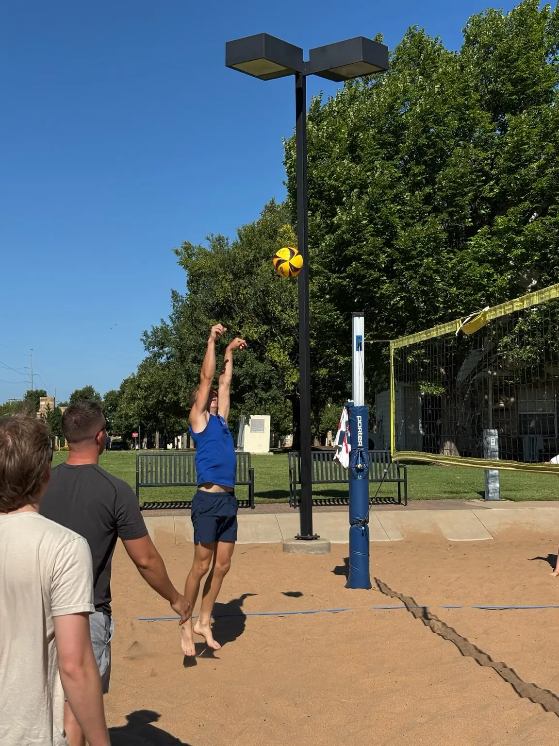 A Sandline player jumping to play the ball near the net