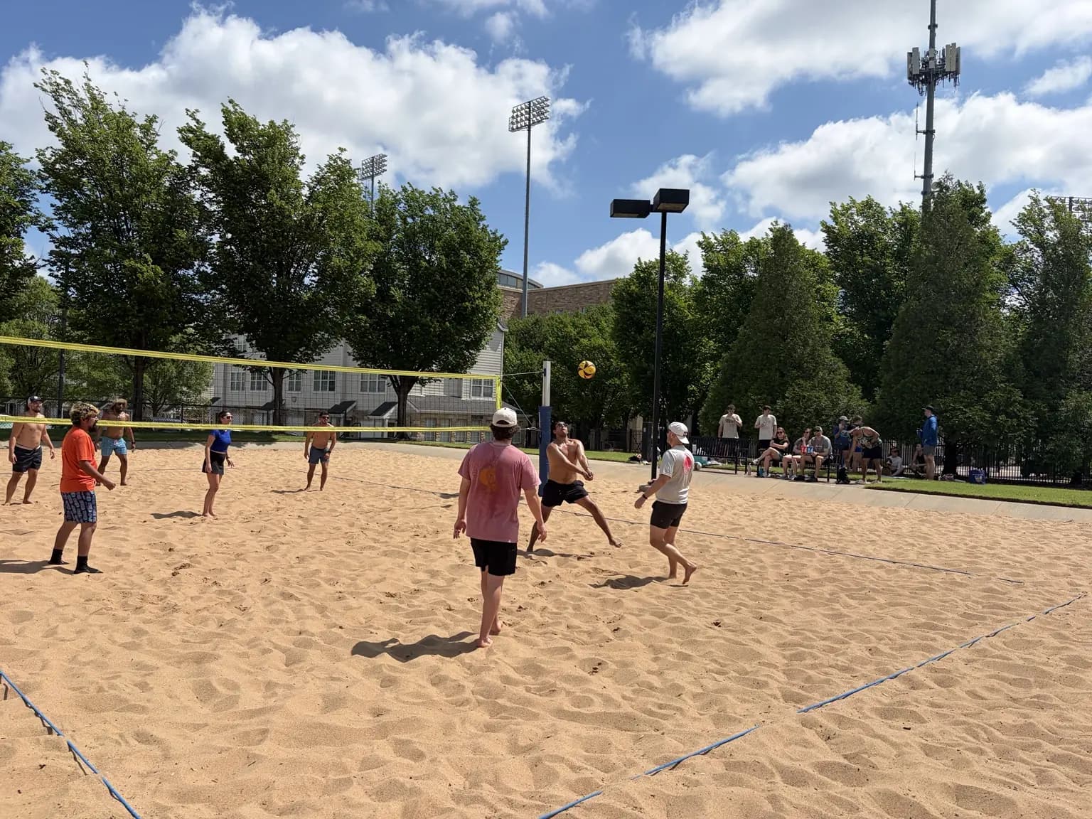 Sandline players tracking a volleyball during a rally at TU Sand Courts